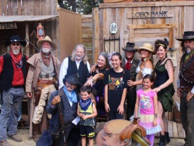 group photo with cowboys and children