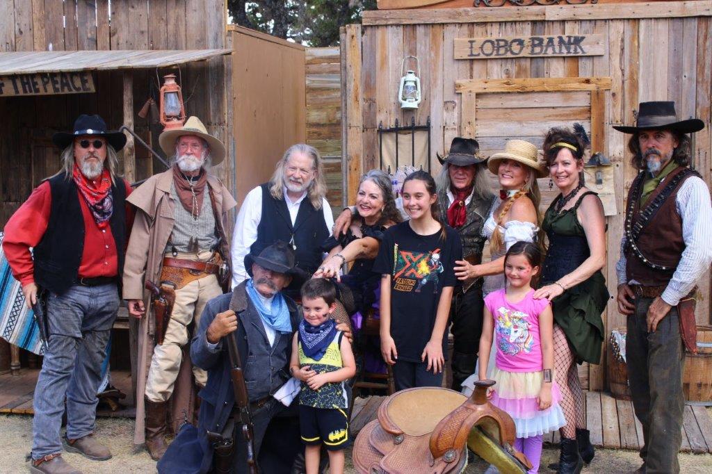 group photo with cowboys and children